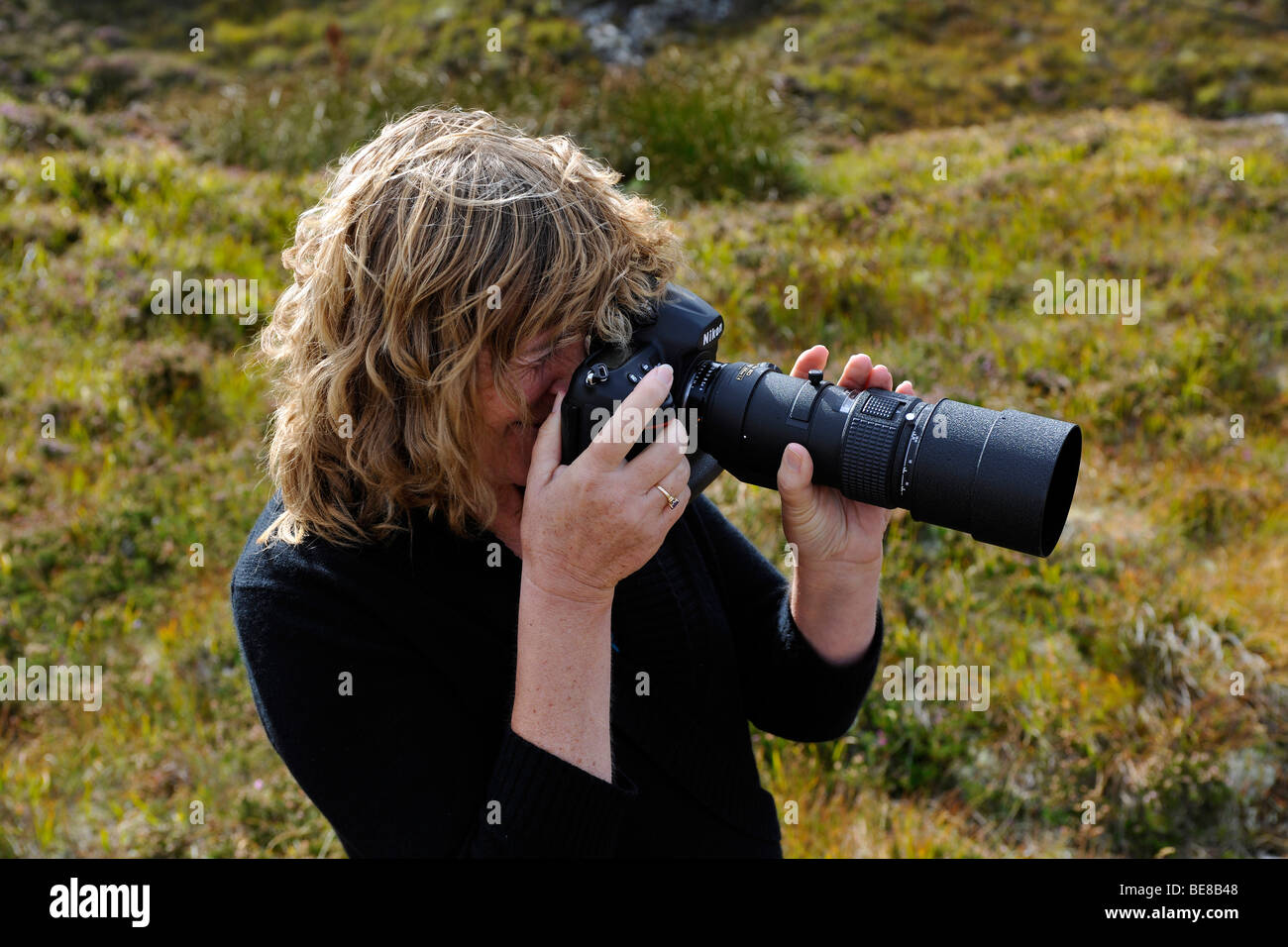 Female photographer taking photograph. Stock Photo