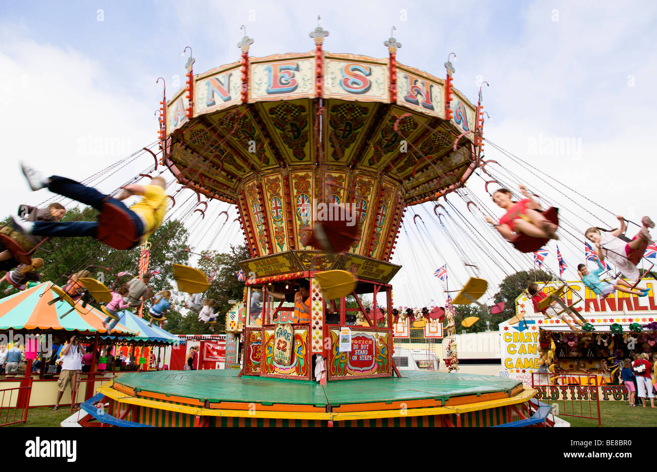 England West Sussex Findon Village Sheep Fair Children in motion riding on a swing carousel. Stock Photo