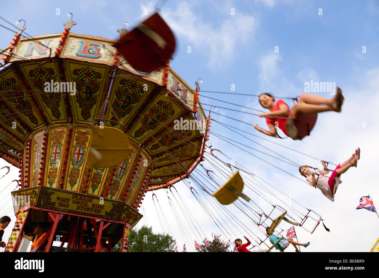 England West Sussex Findon Village Sheep Fair Children in motion riding on a swing carousel. Stock Photo