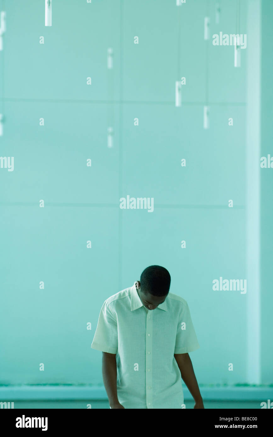 Young male standing with head down Stock Photo Alamy