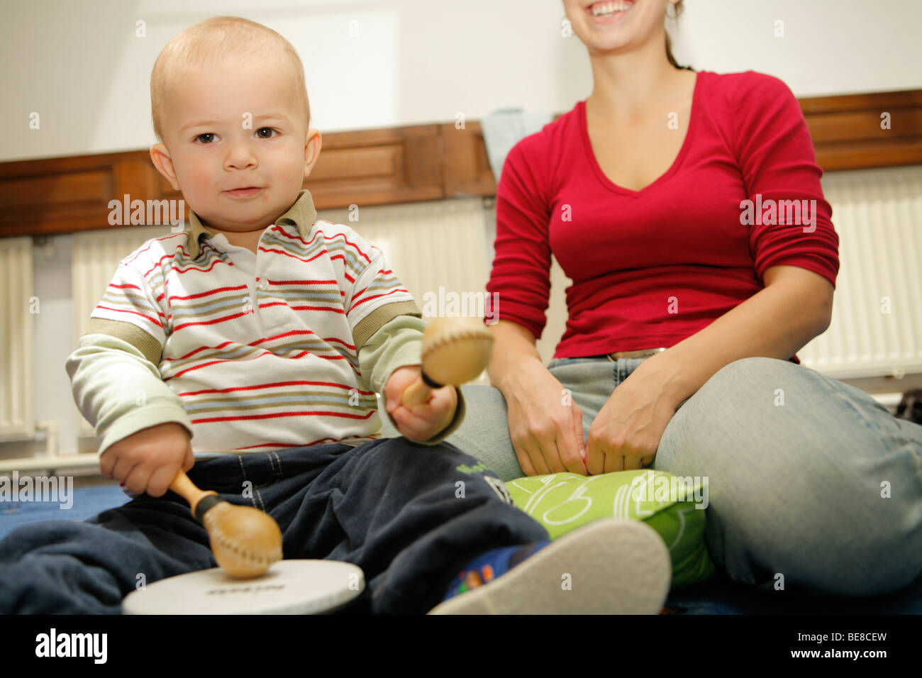 Mothers and children in baby center playing music. Baby music. Stock Photo