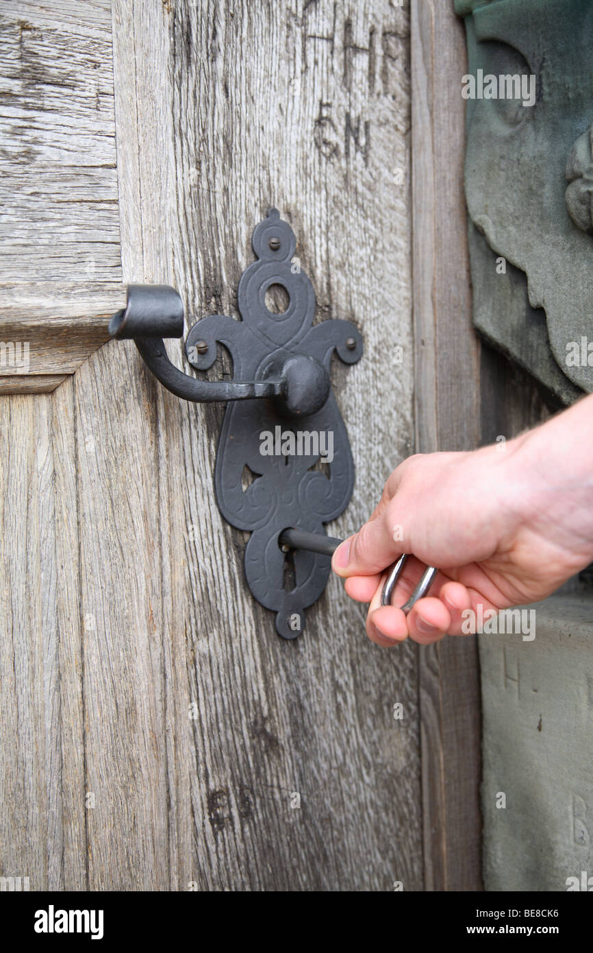 Unlocking an old door to the  renaissance castle Kronborg in Elsinore, Denmark Stock Photo