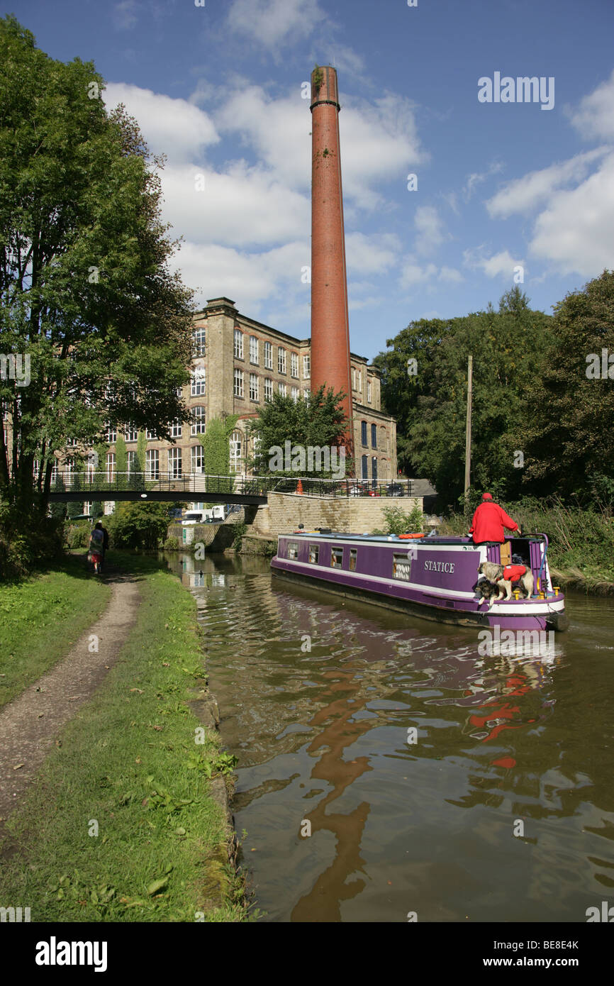 Town of Bollington, England. View of a canal boat on Macclesfiled Canal at Bollington, with Clarence Mill in the background. Stock Photo