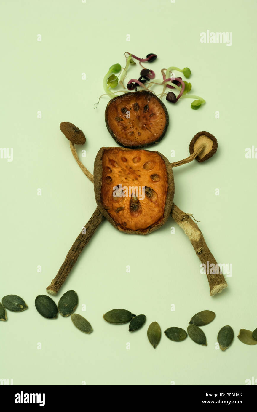 Bean sprouts, dried lotus root, and mushrooms arranged in form of human figure Stock Photo