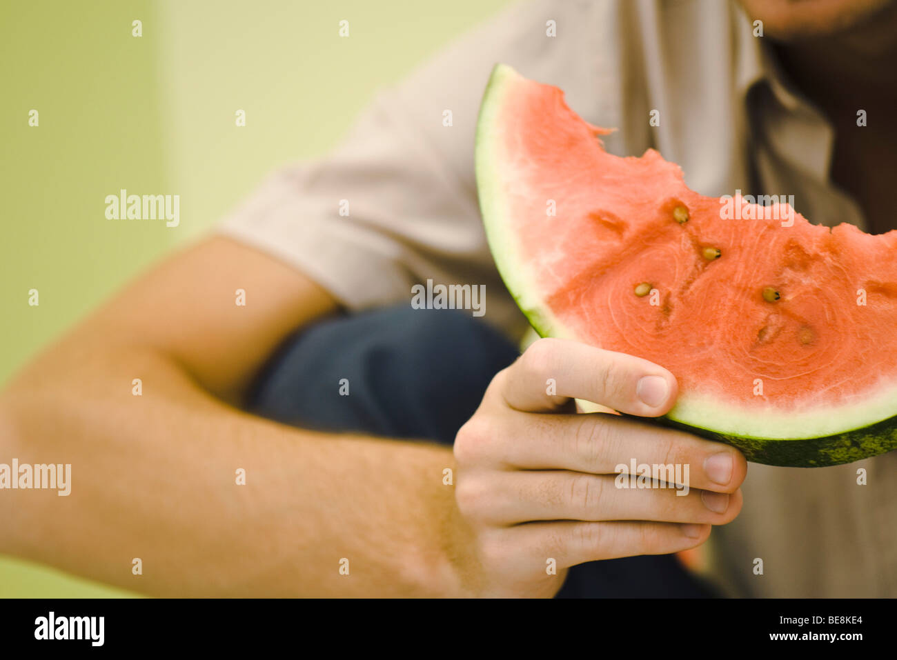 Man holding slice of watermelon, cropped Stock Photo