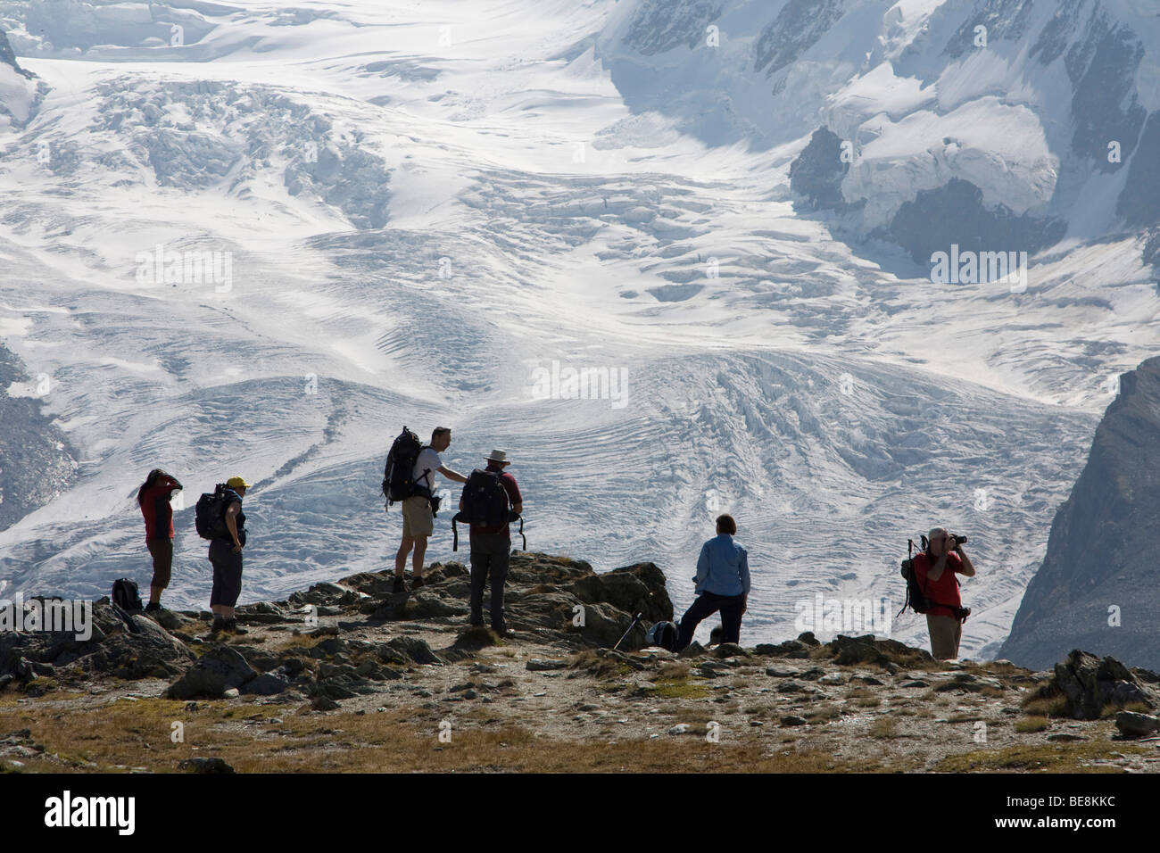 glacier beyond group of hikers swiss alps switzerland europe Stock Photo