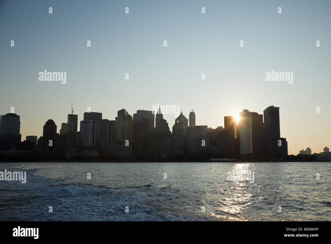 Lower Manhattan skyline from Upper New York Bay at sunrise. Stock Photo