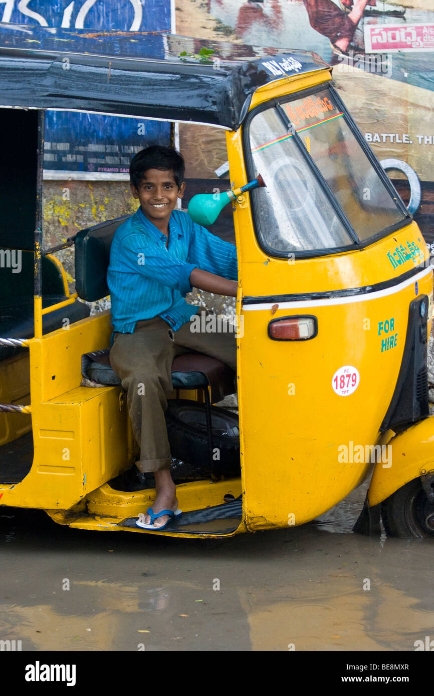 Rickshaw riding through flooded streets in Hyderabad India Stock Photo