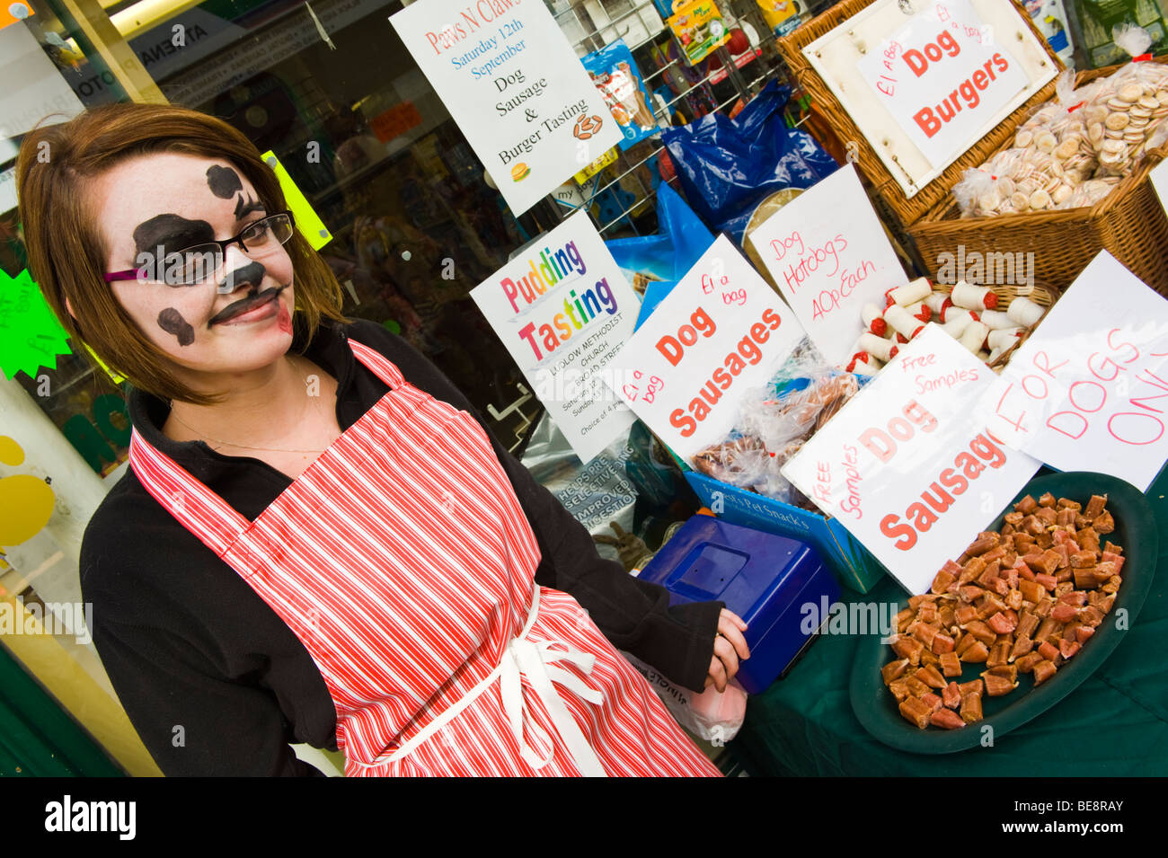 Pet shop selling dog treats with teen assistants made up as dalmatians during Ludlow Food Festival Shropshire England UK Stock Photo