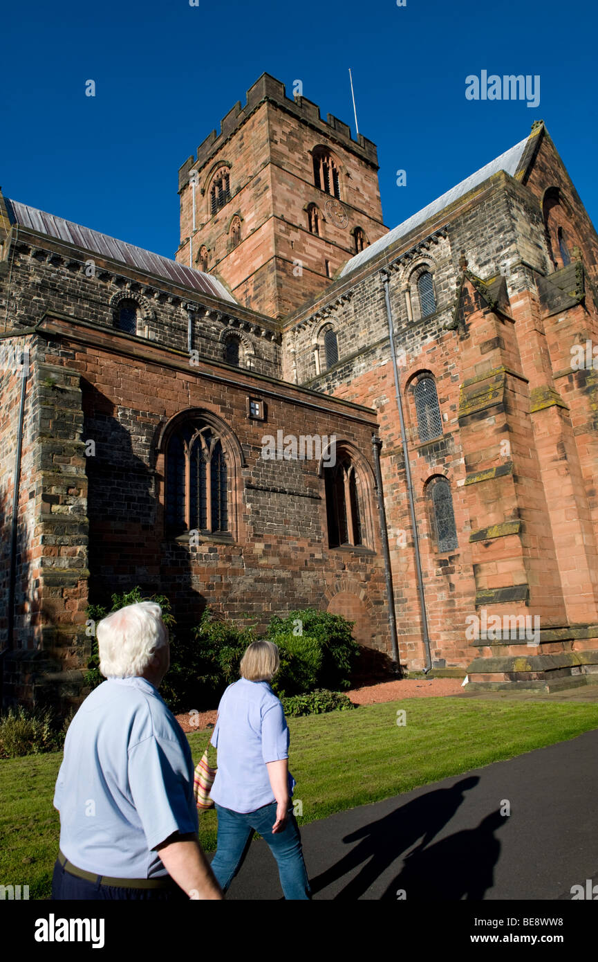 Public walking past Carlisle Cathedral, Carlisle, Cumbria, UK Stock Photo