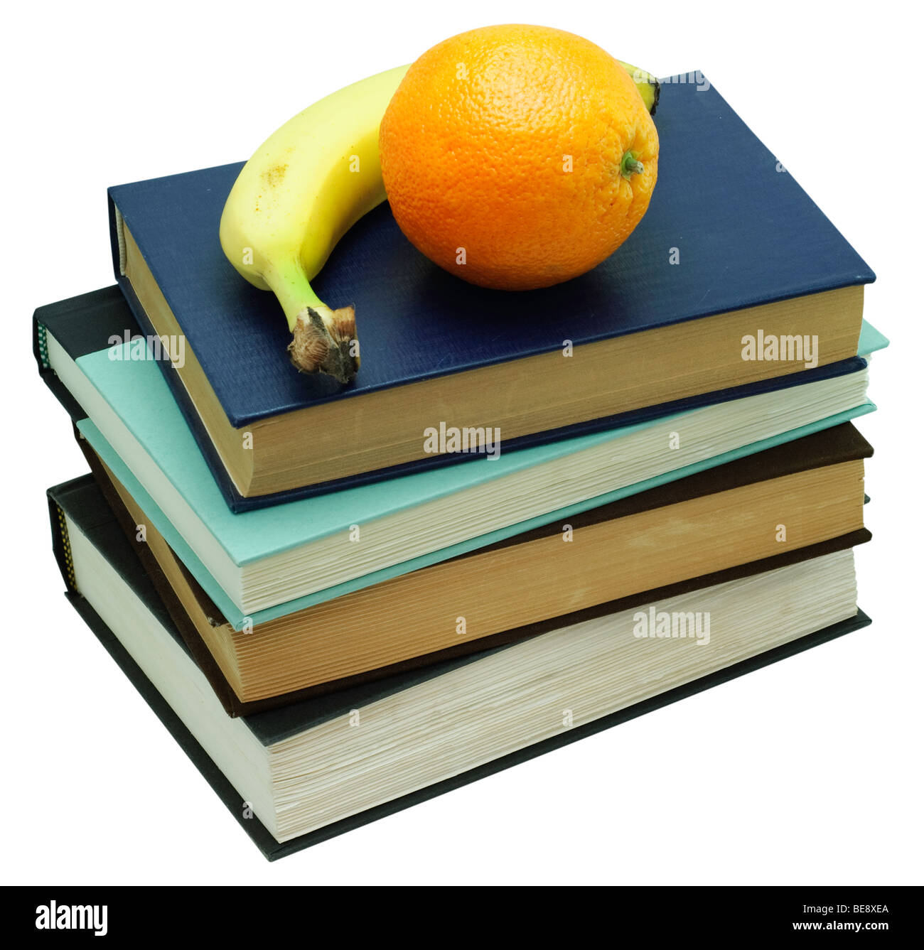 Orange and Banana on a stack of four old books. Isolated on white