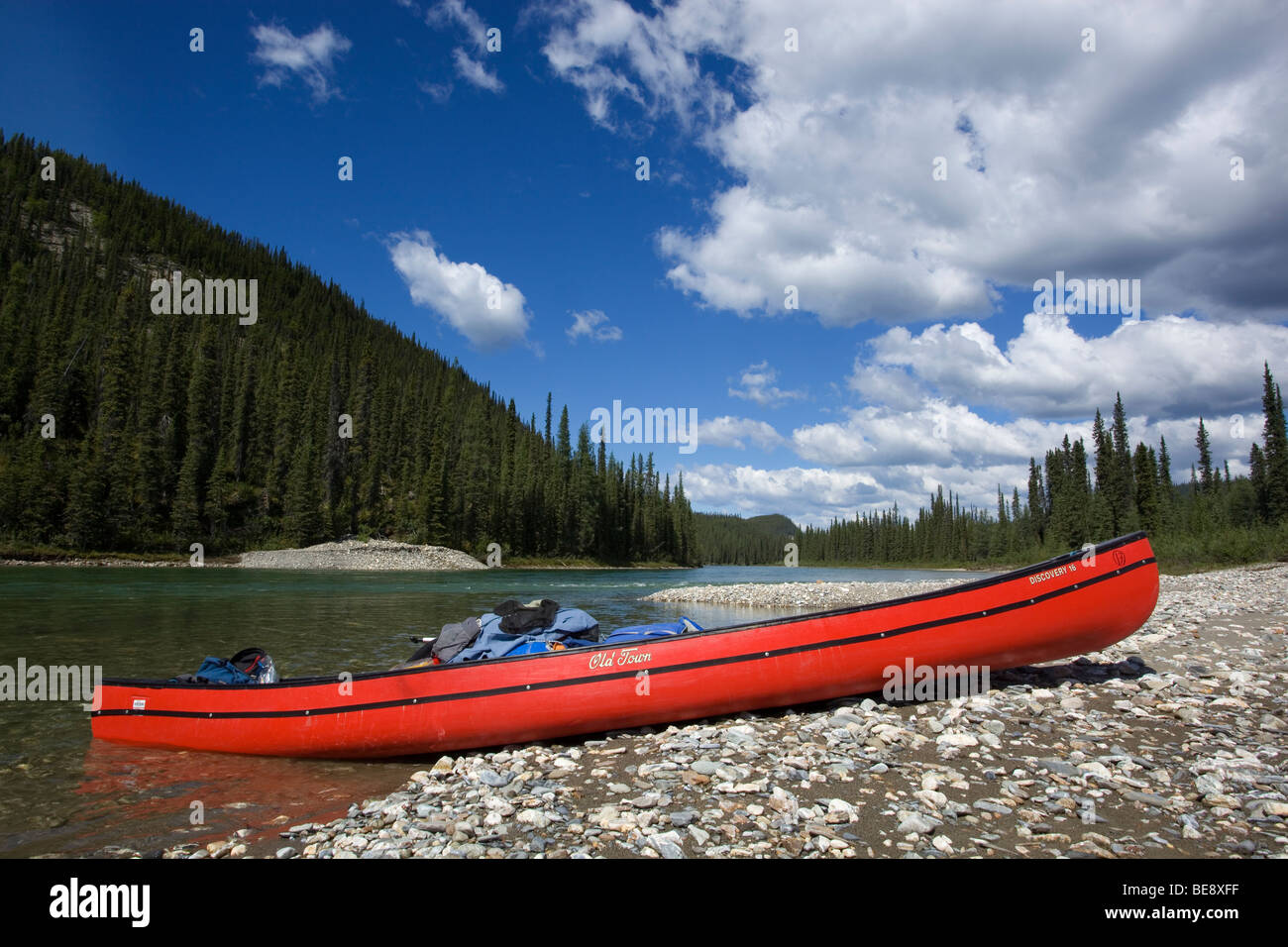 Loaded canoe on a gravel bar, upper Liard River, Yukon Territory, Canada Stock Photo