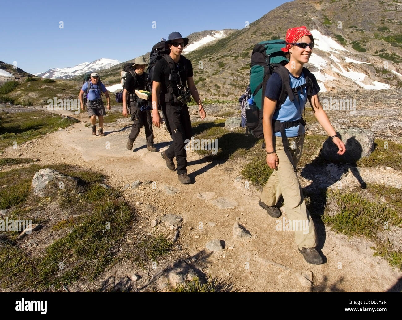 Group of young hikers hiking, backpacking, backpack, historic Chilkoot Trail, Chilkoot Pass, near Happy camp, alpine tundra, Yu Stock Photo