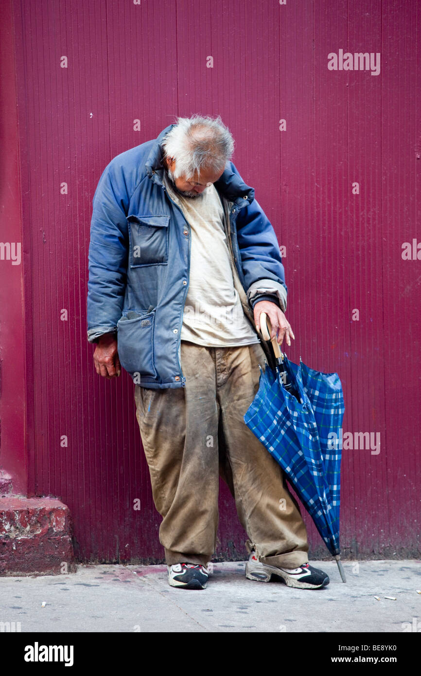 Homeless asian man in Chinatown in Manhattan New York City Stock Photo