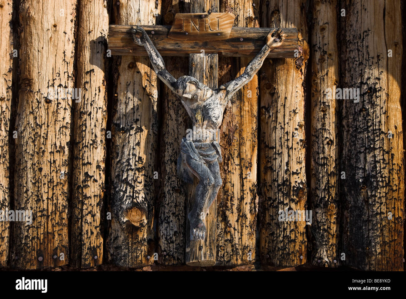 Wooden crucifix on a mountain lodge on the Plaetzwiese high plateau, Dolomites, South Tyrol, Italy, Europe Stock Photo