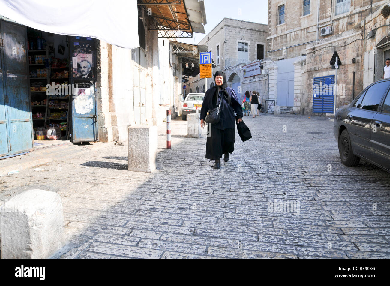 Israel, Jerusalem, Arab woman walks in an alley Stock Photo