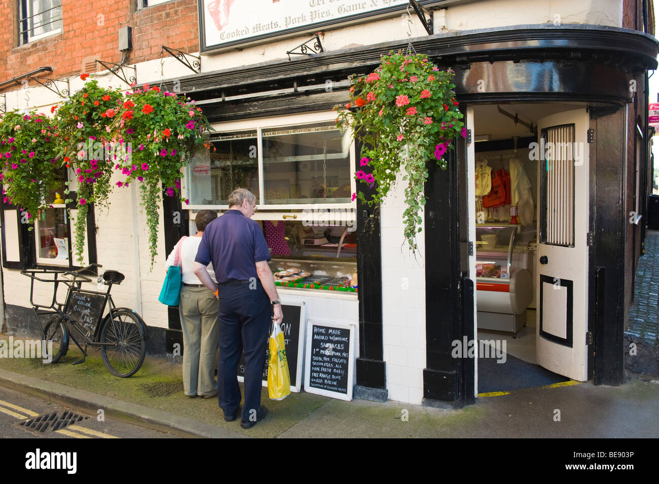 People Window Shopping At Butchers Shop Selling Farmed And