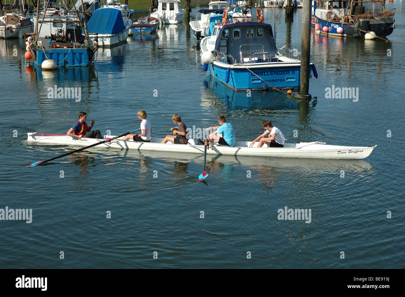 rowing boat and crew, Lymington harbour, Hampshire, England, UK Stock