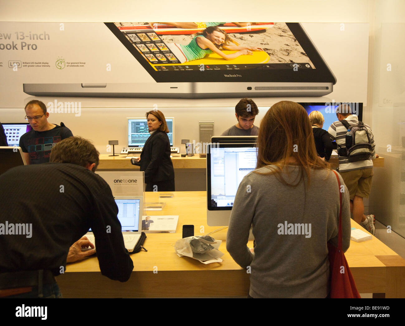 Customers inside apple store testing hi-res stock photography and ...