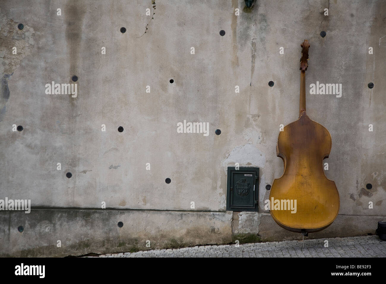 Double bass leaning against wall. Stock Photo