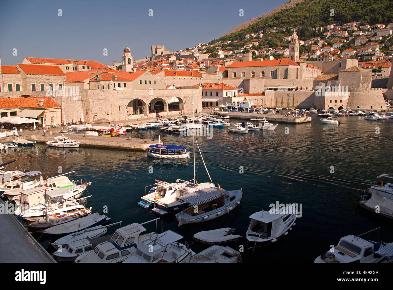 Croatia; Hrvartska; Kroatien; Dubrovnik, Fishboat and small tourist boat harbor, harbour, surrounded by old City Stock Photo