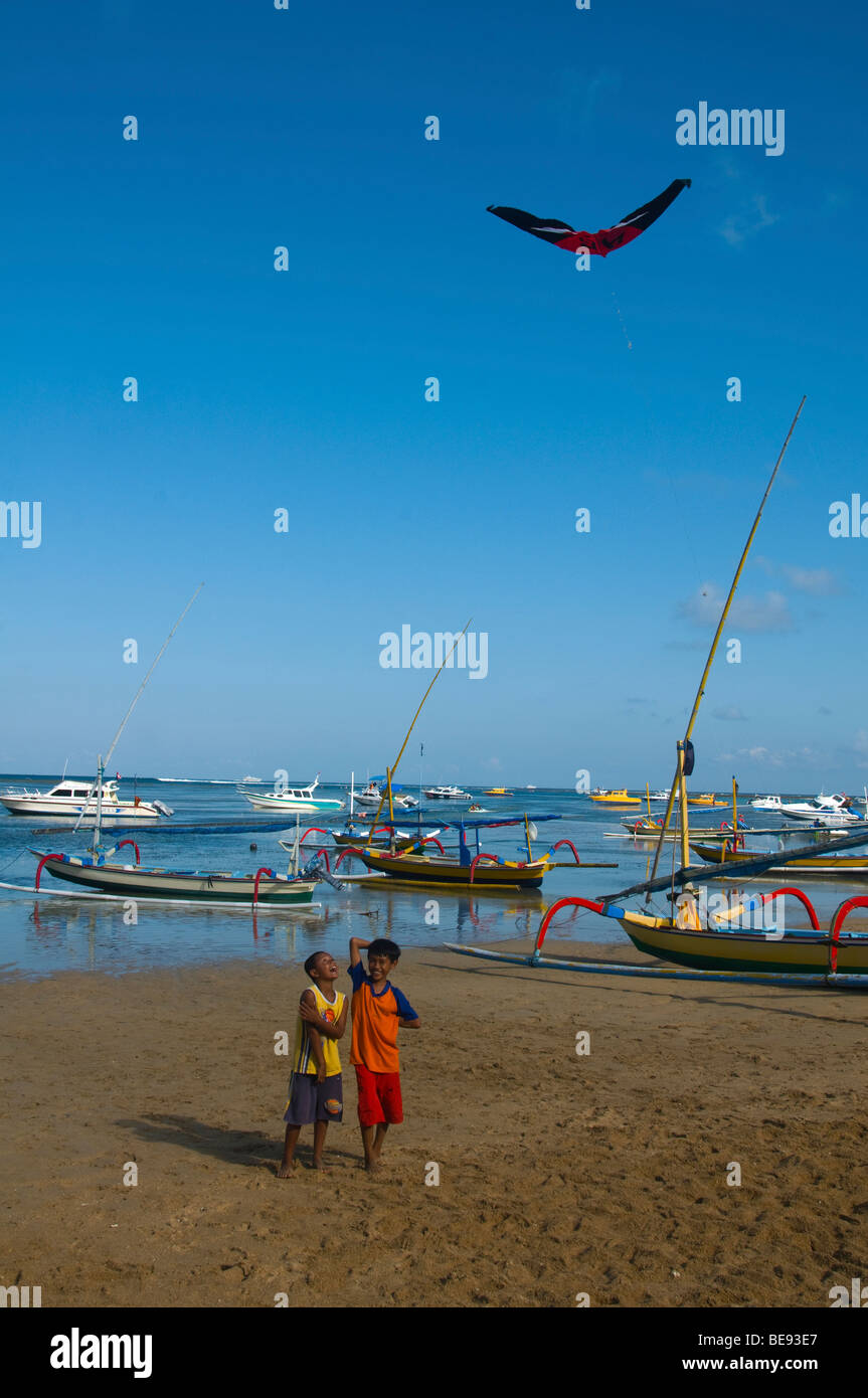 boys flying kites on the beach in Bali Indonesia Stock Photo Alamy