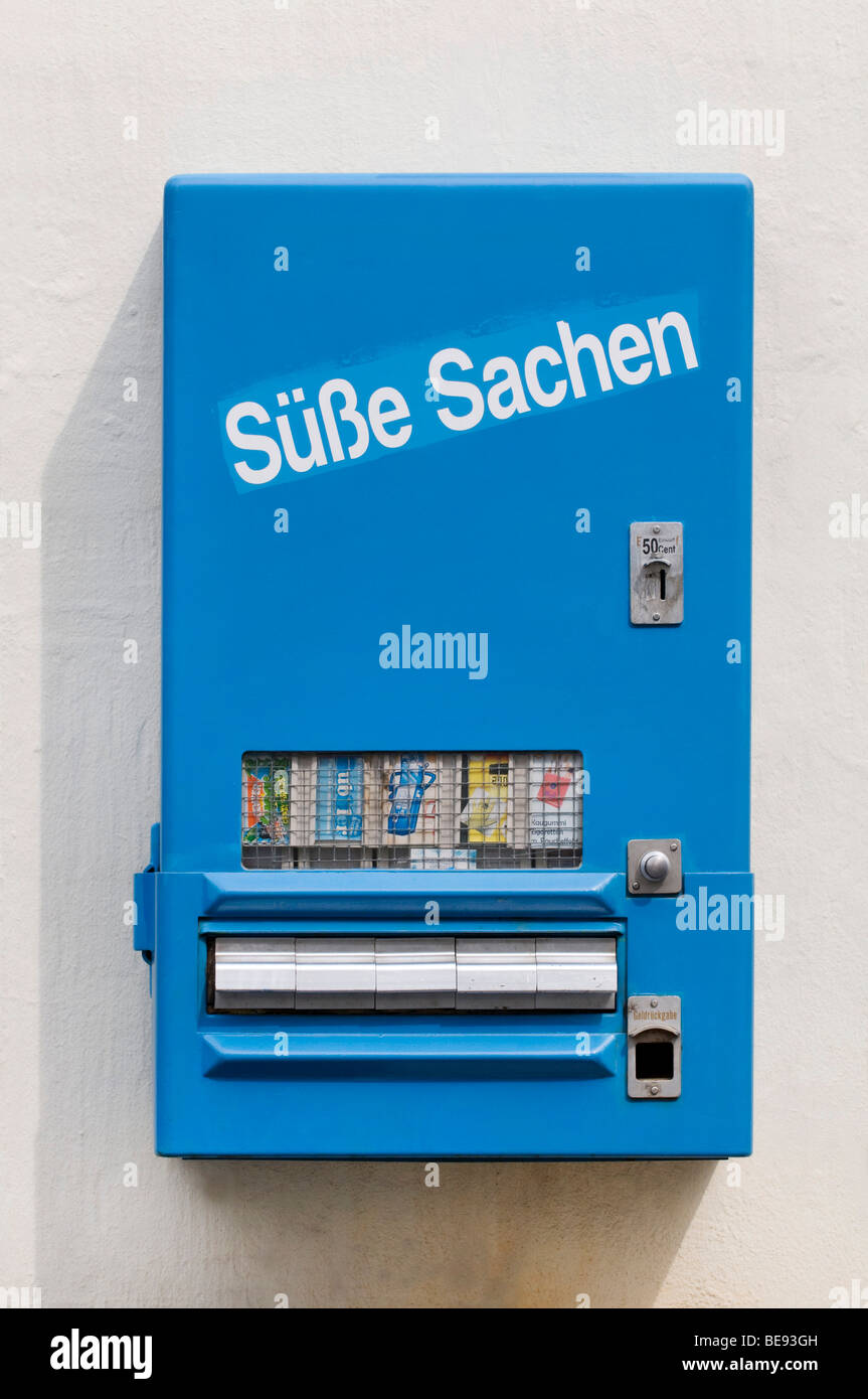 Blue candy machine with drawers to remove the product, labelled Suesse Sachen, German for Sweet Things, 50 cent coin slot Stock Photo