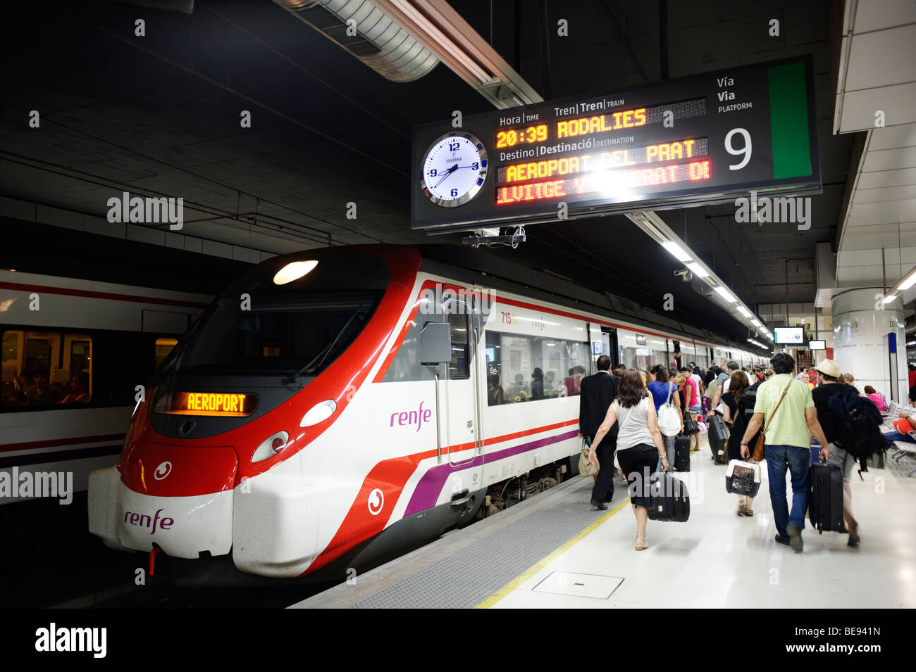 People boarding Renfe airport metro train. Sants. Barcelona. Spain Stock Photo