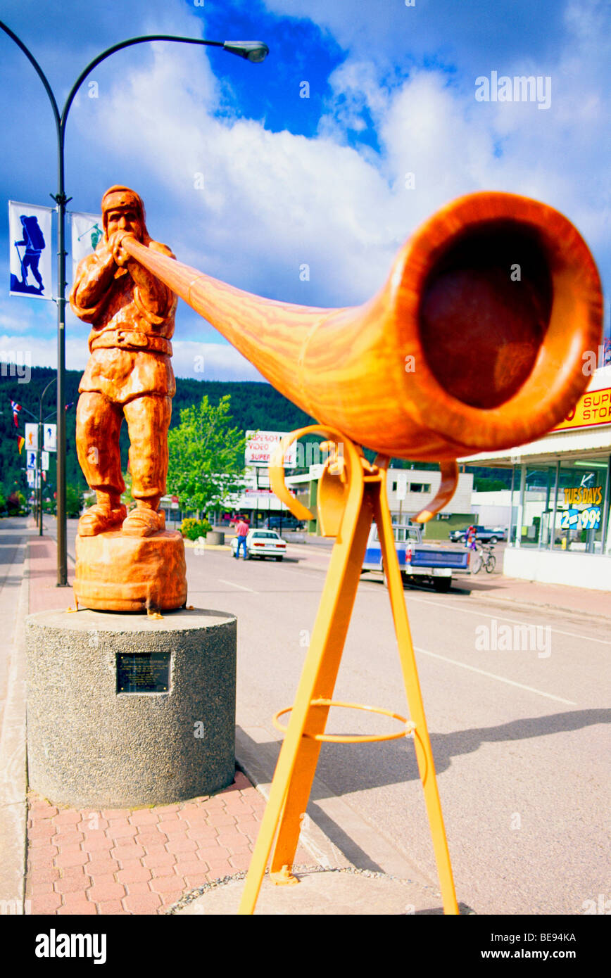 Smithers, BC, Northern British Columbia, Canada - Carved Wooden Alpenhorn Player Statue, Man blowing Alphorn Stock Photo