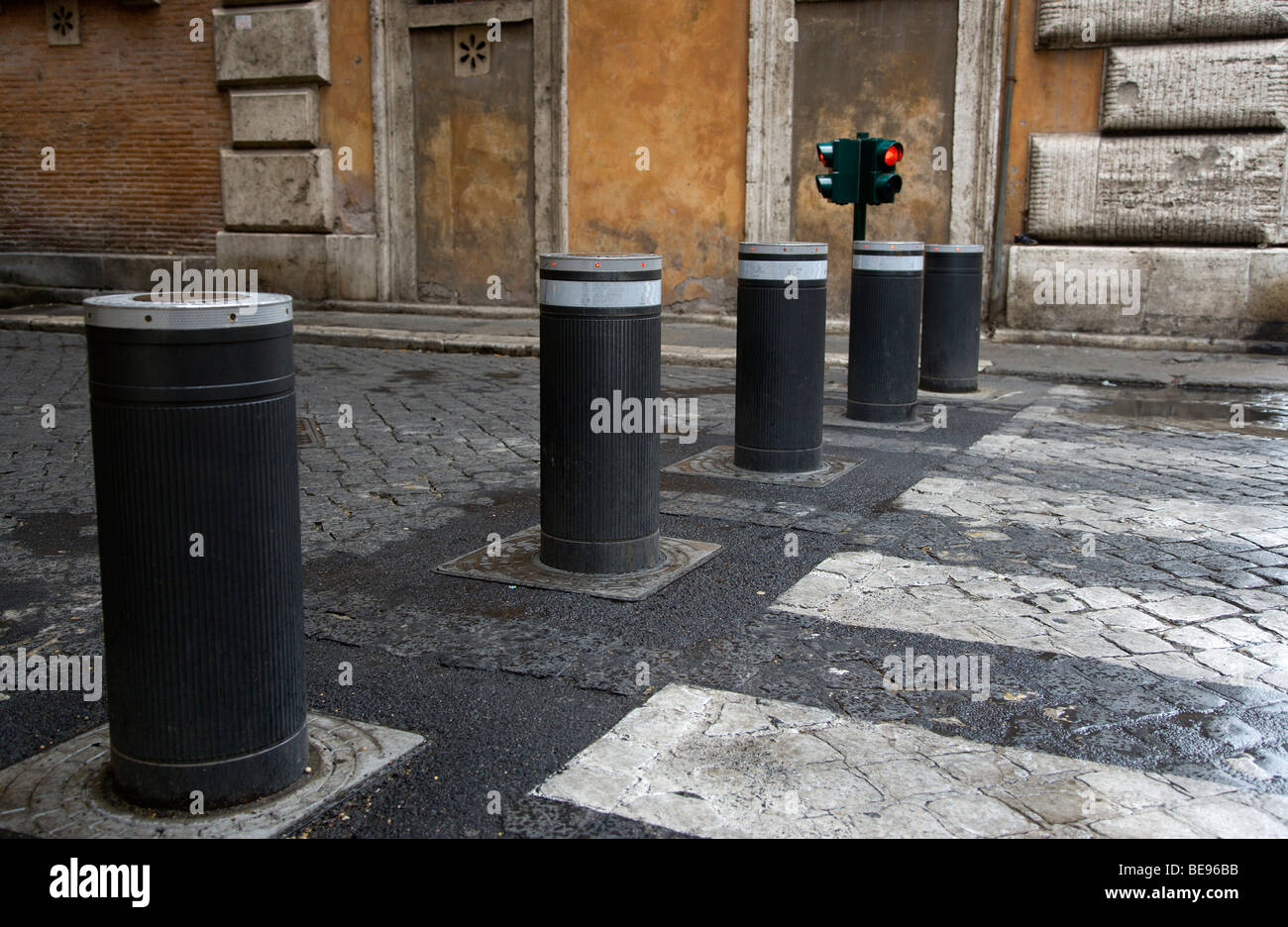 ITALY Rome Lazio Automatic rising bollards barrier and pedestrian crossing in street with red and green traffic control lights. Stock Photo
