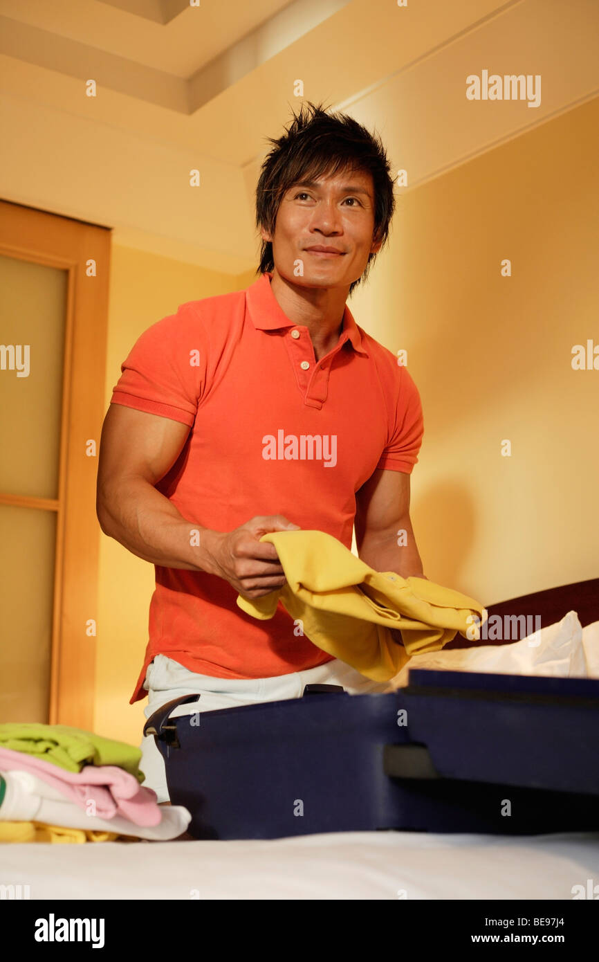 man packing suitcase Stock Photo - Alamy
