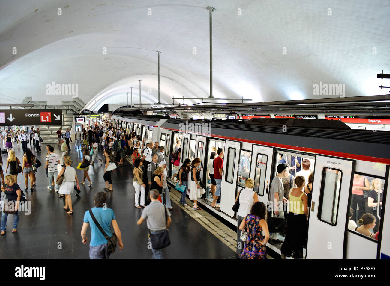 People boarding train at busy metro station. Barcelona. Spain Stock