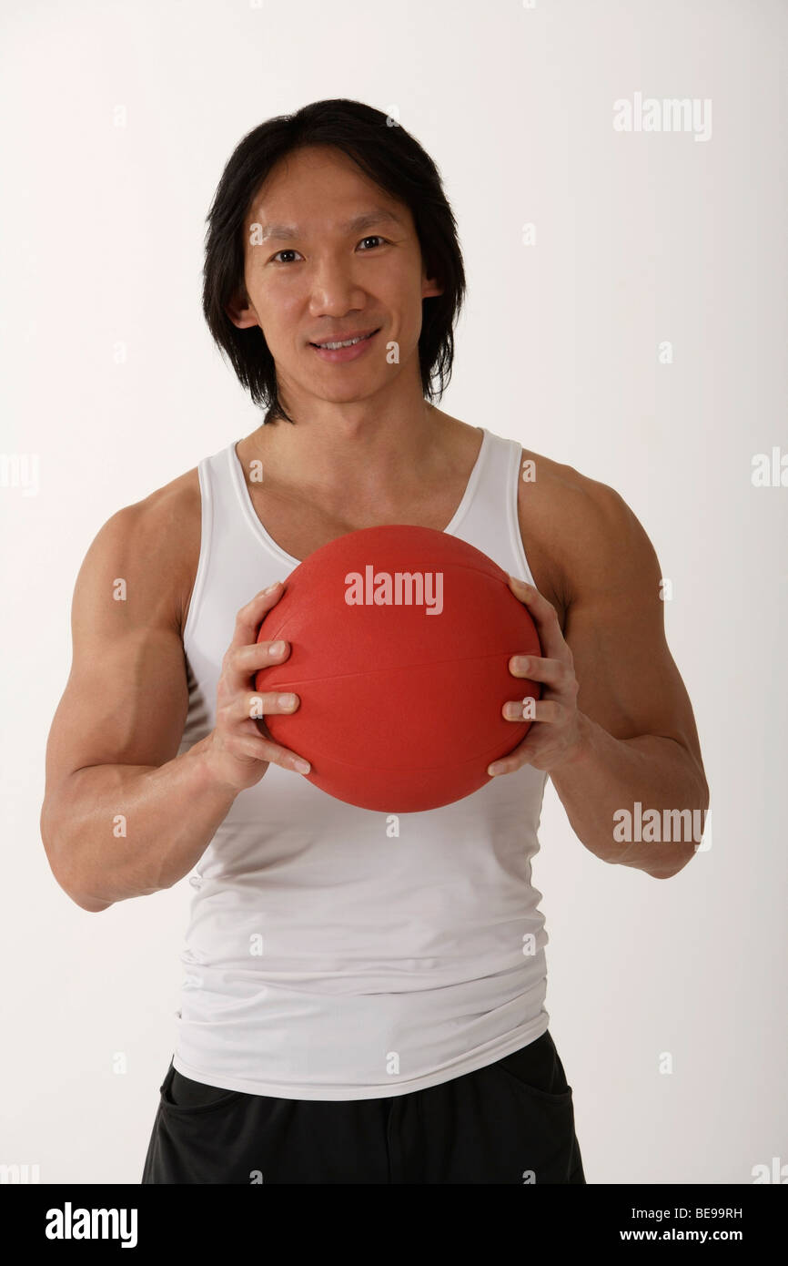 Chinese man holding medicine ball Stock Photo Alamy