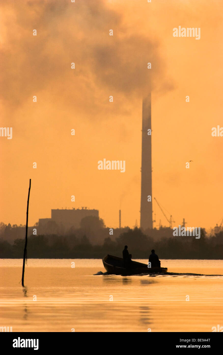 small scale fishing in the oderdelta with heavy industry on the shoreline Stock Photo