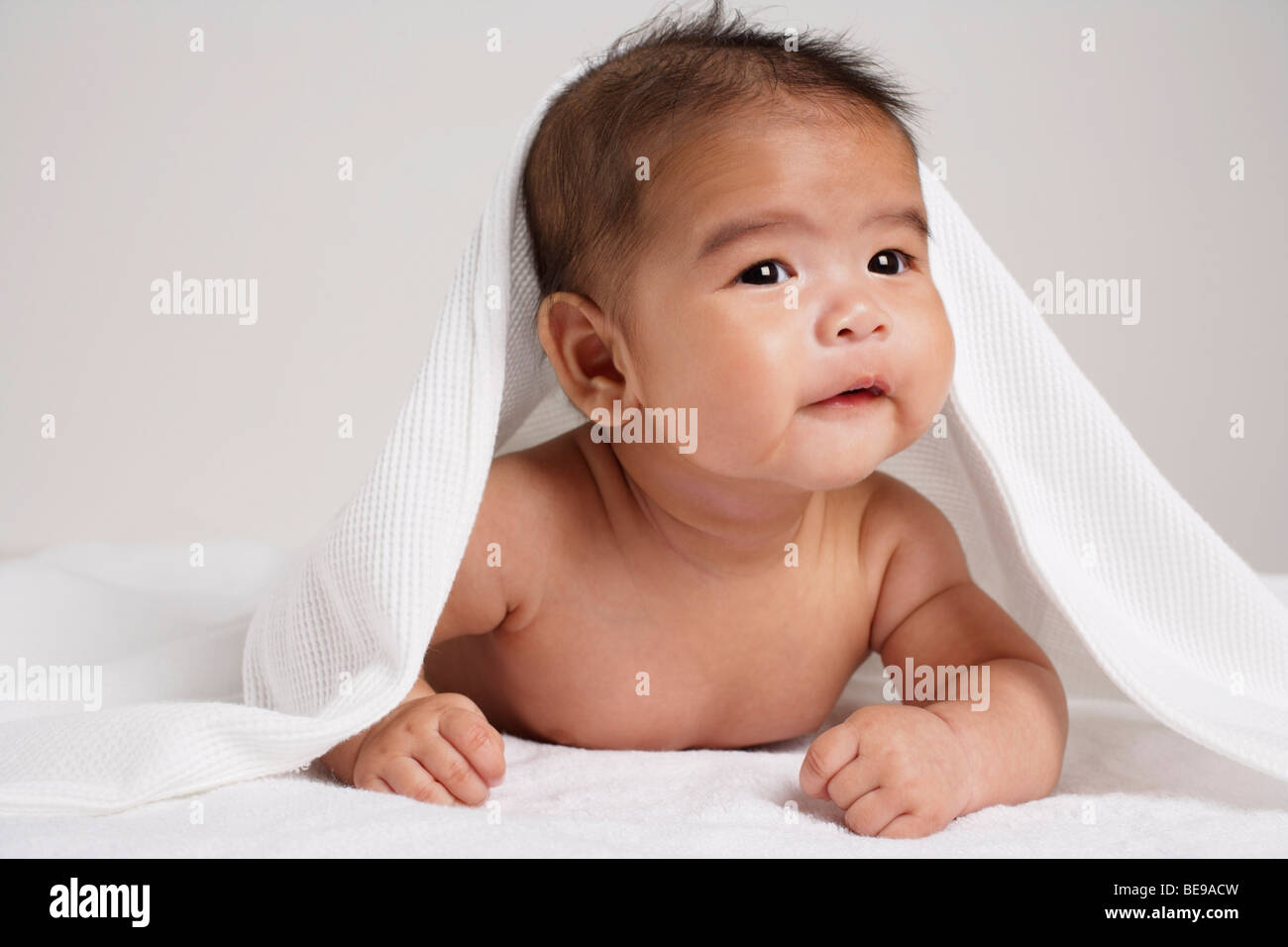 Happy Chinese baby with blanket over his head Stock Photo Alamy