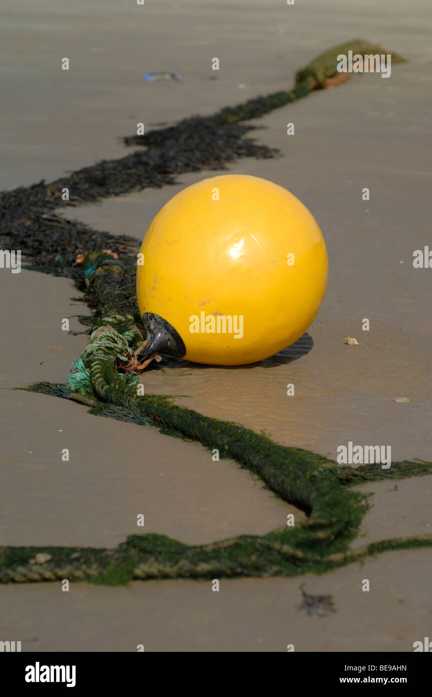 Yellow buoy on a sandy beach Stock Photo Alamy