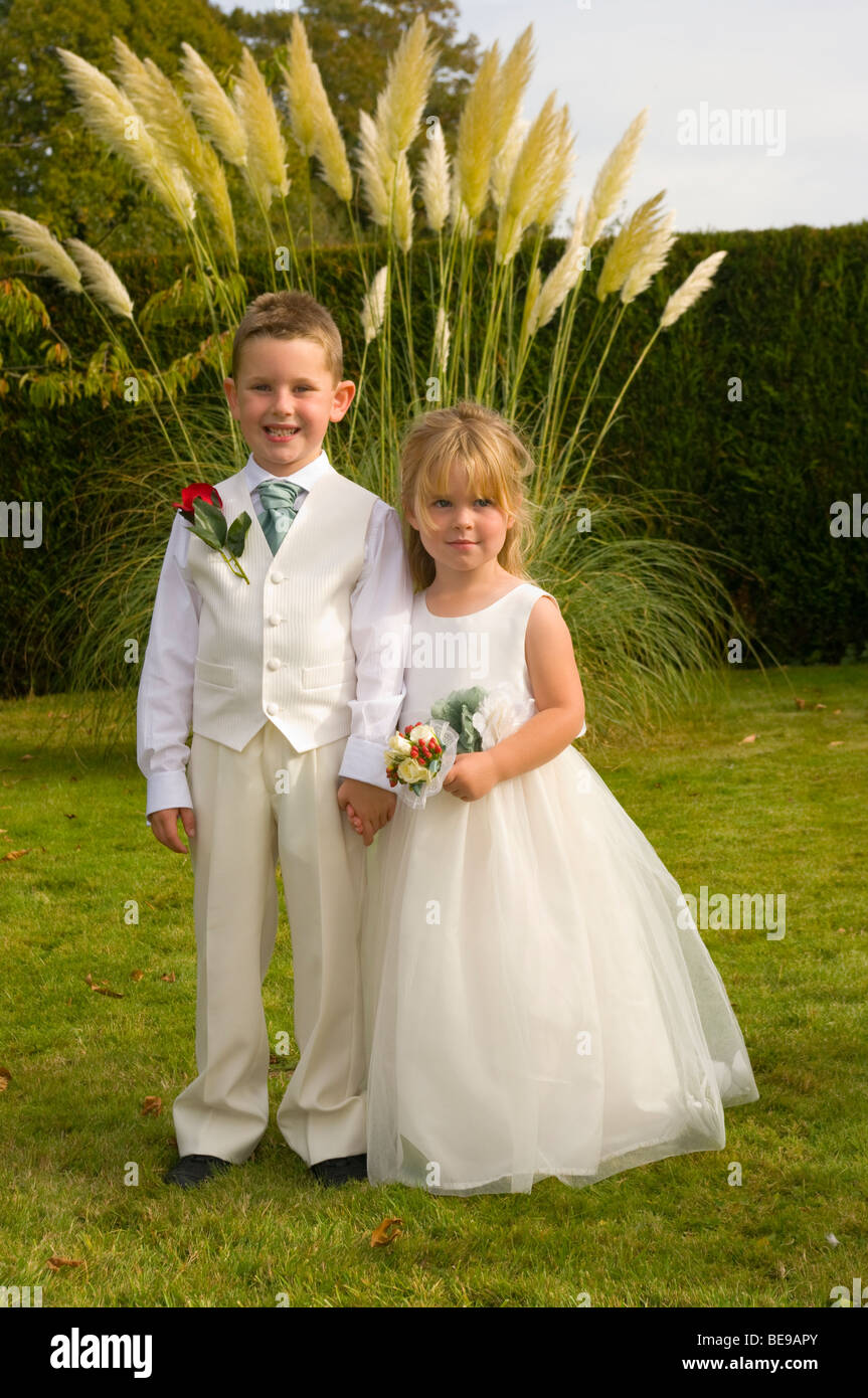 Young Bridesmaid and Pageboy In A Garden Stock Photo Alamy