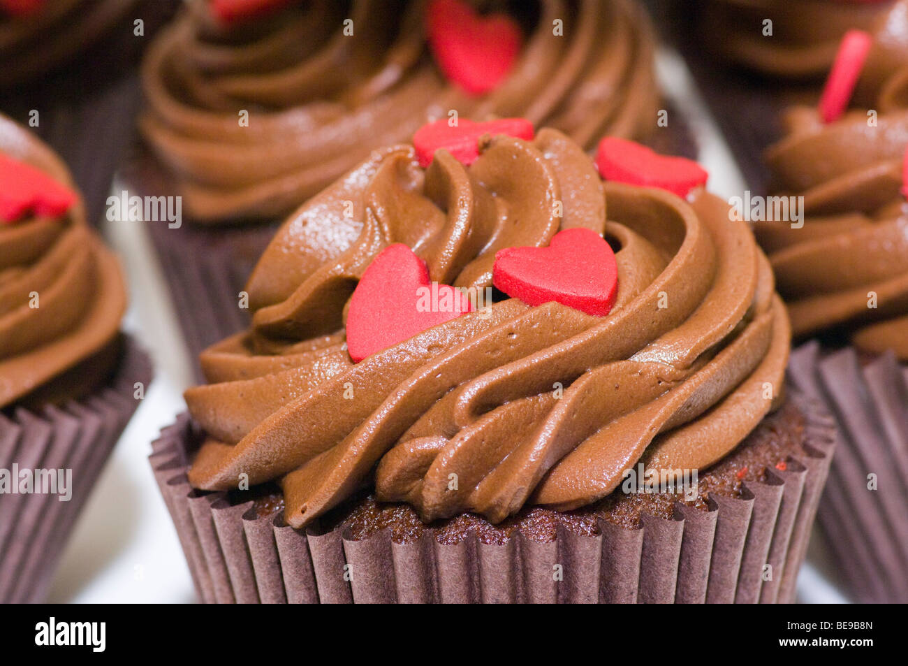 Chocolate Cream Cup Cakes With Red Love Hearts Stock Photo