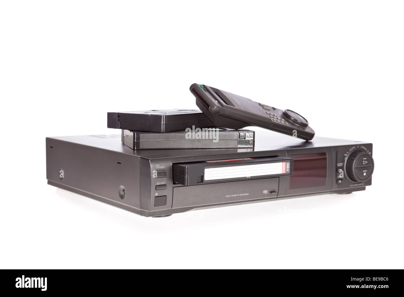 Old Video Cassette Recorder ejecting tape isolated on white background