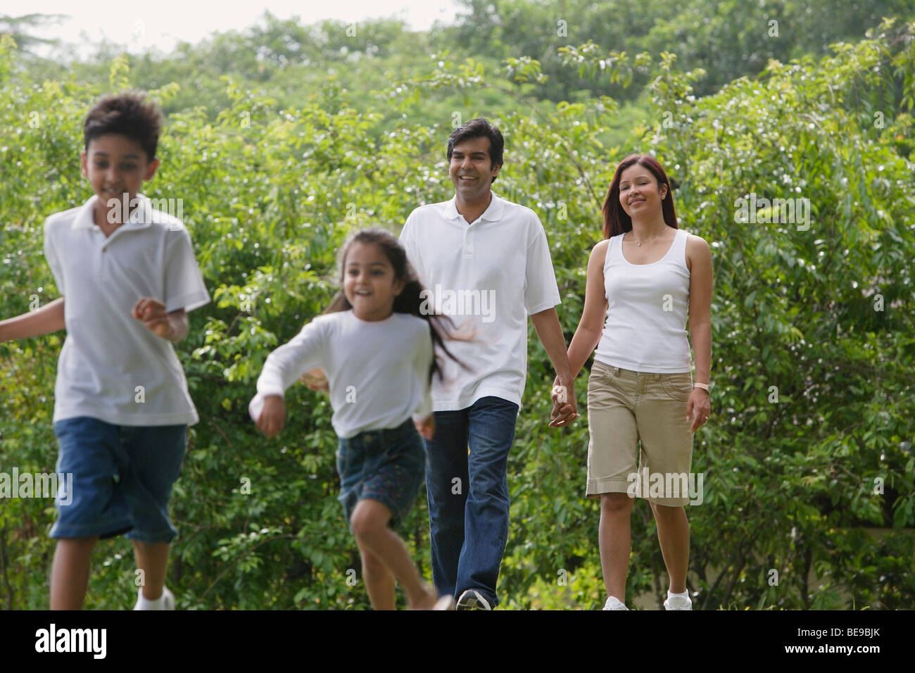 A family walk together in the park Stock Photo - Alamy