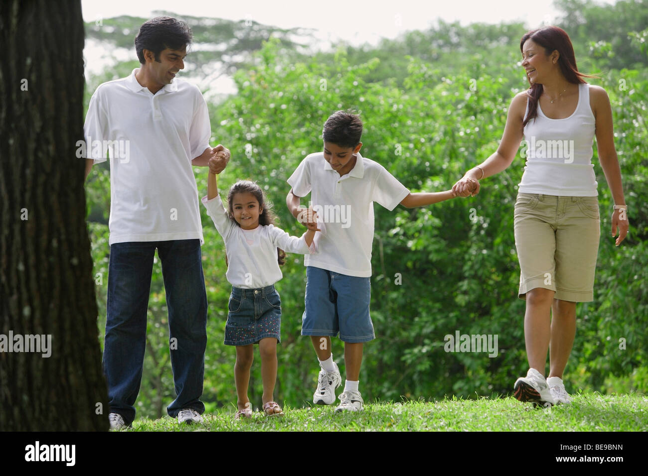 A family walk together in the park Stock Photo - Alamy