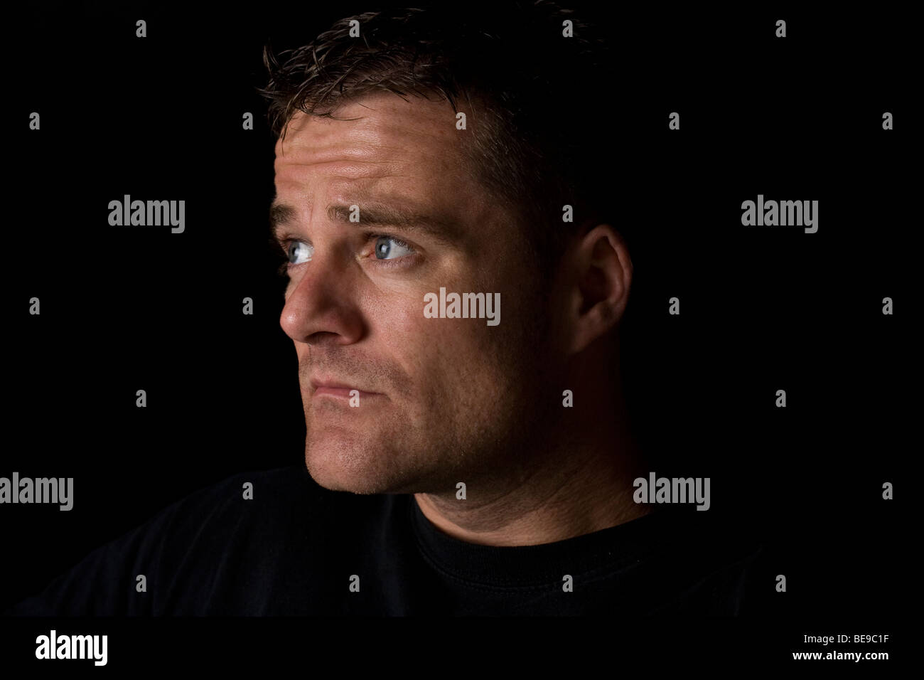 A portrait of a man staring away from the camera Stock Photo