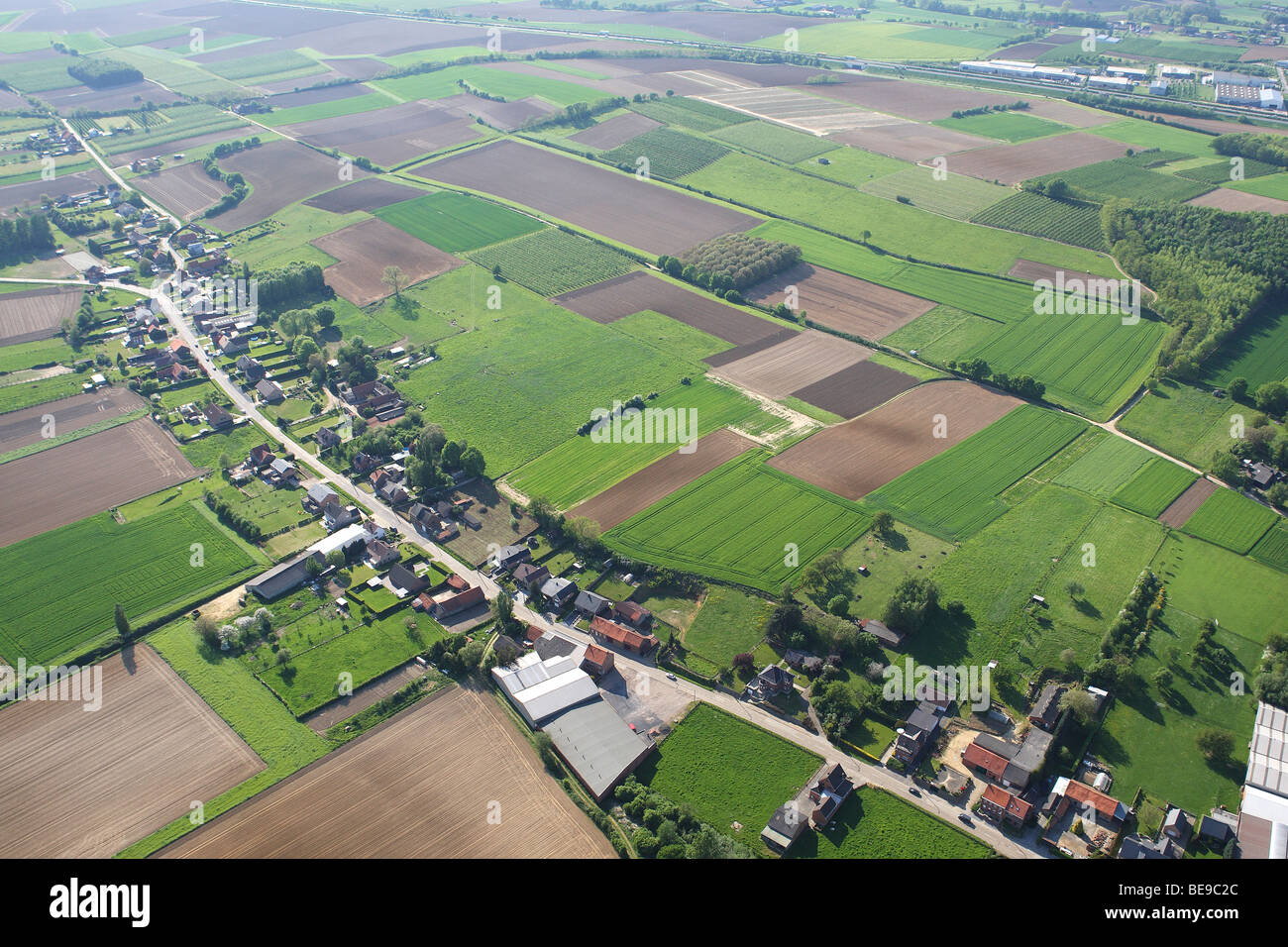 Ribbon development in agricultural area with fields, grasslands and