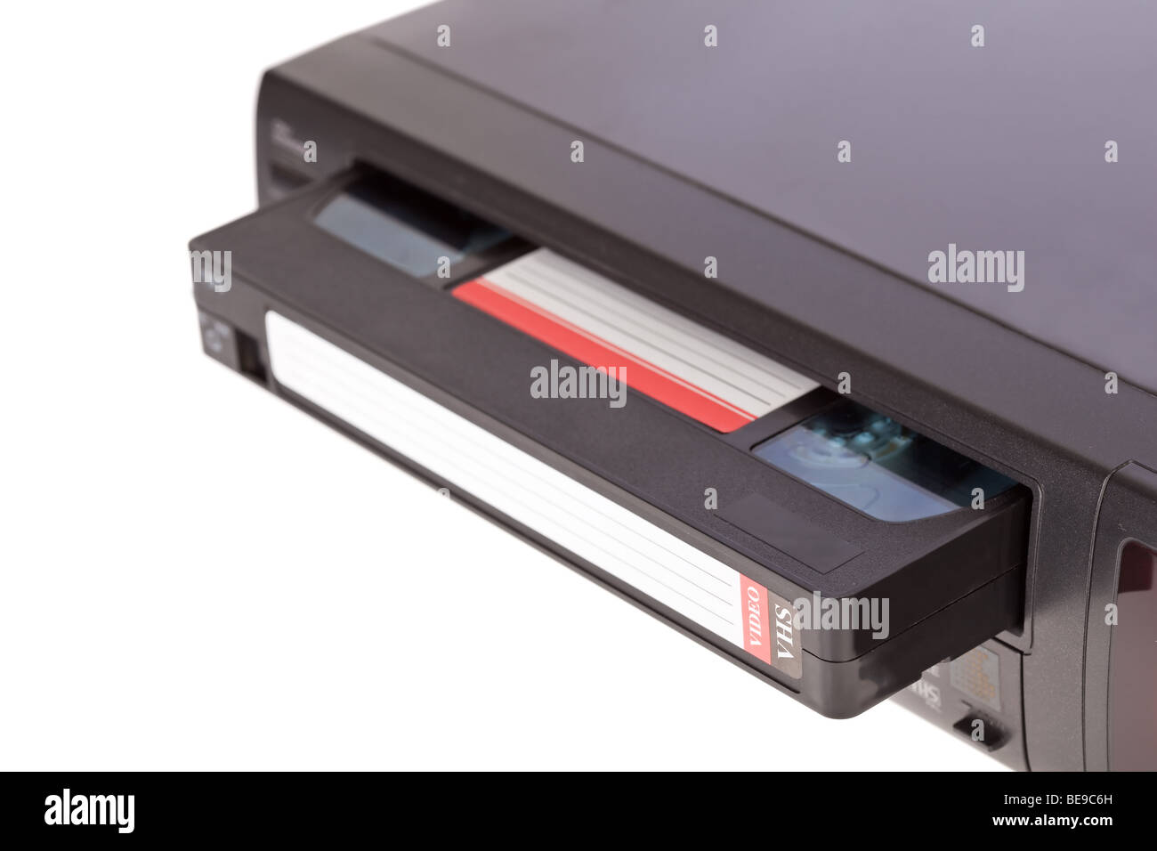 Old Video Cassette Recorder ejecting tape isolated on white background