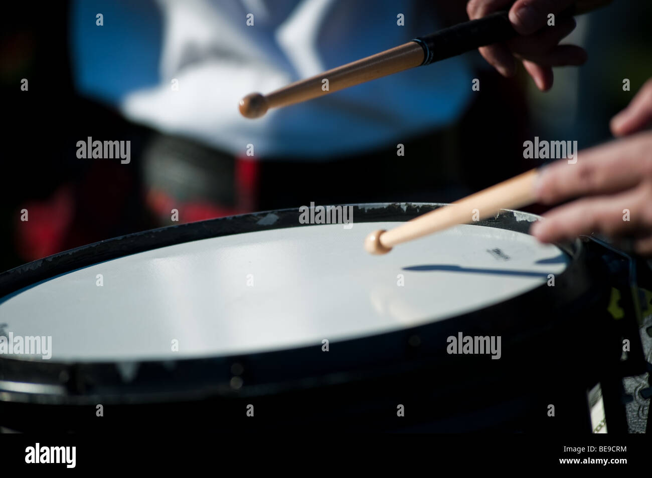 Pipe Band Snare Drummer playing with sticks while marching Stock Photo