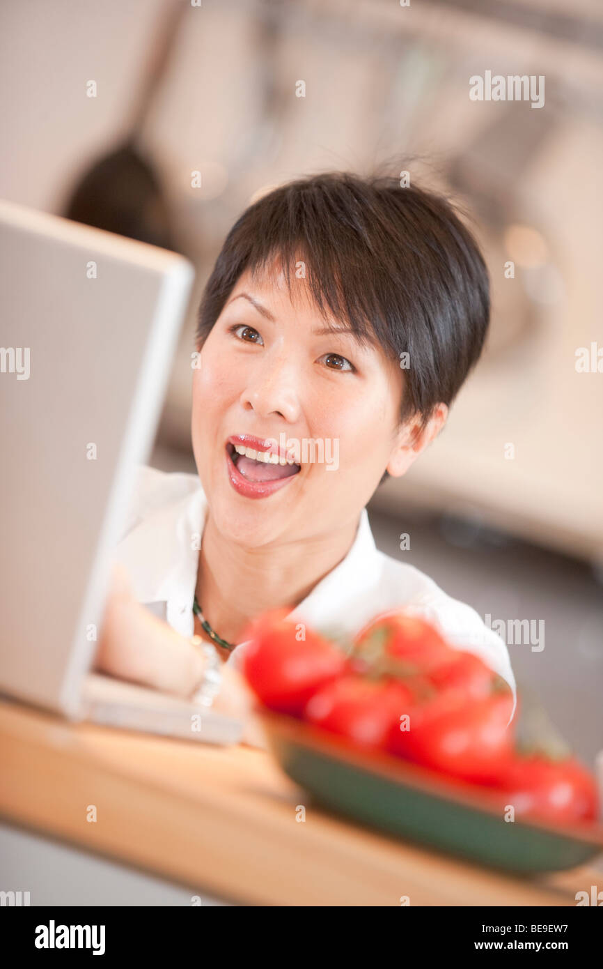 Oriental girl at computer Stock Photo