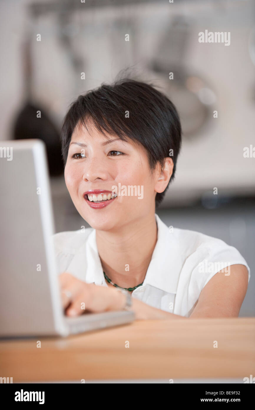 Oriental girl at computer Stock Photo