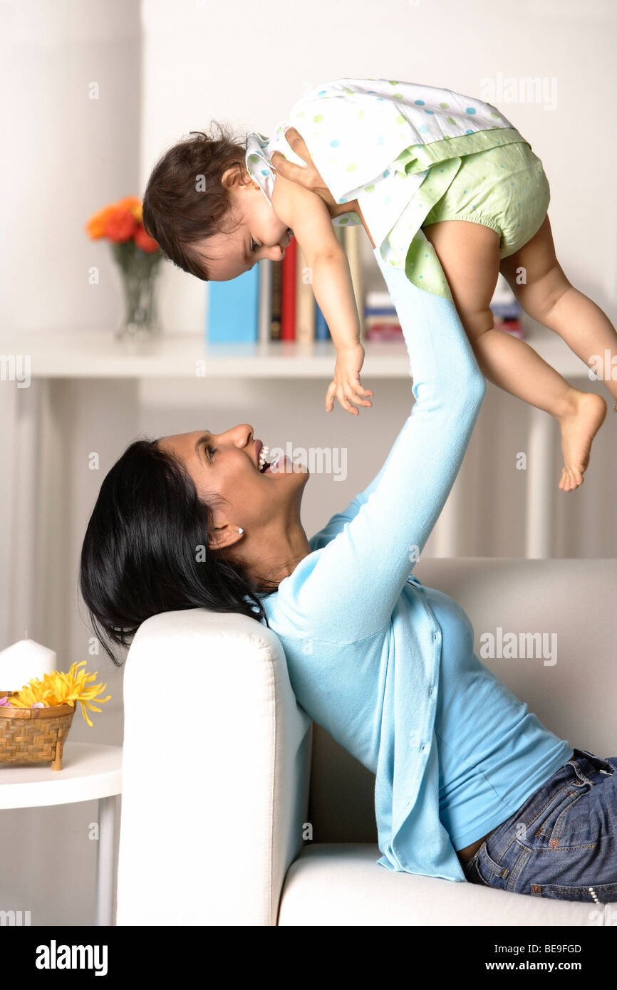 woman holding baby in the air Stock Photo