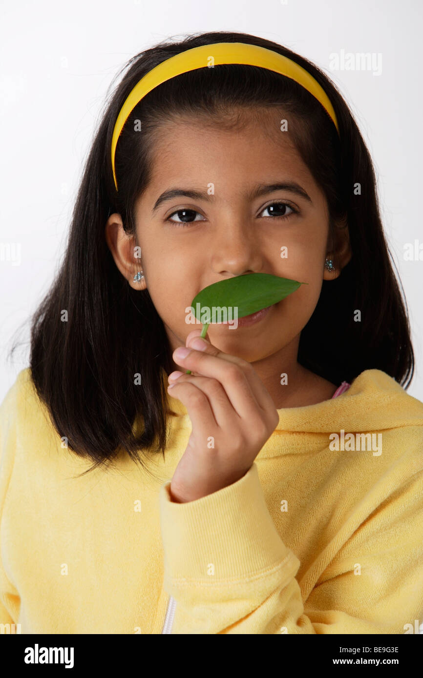 Girl smelling green leaf Stock Photo Alamy
