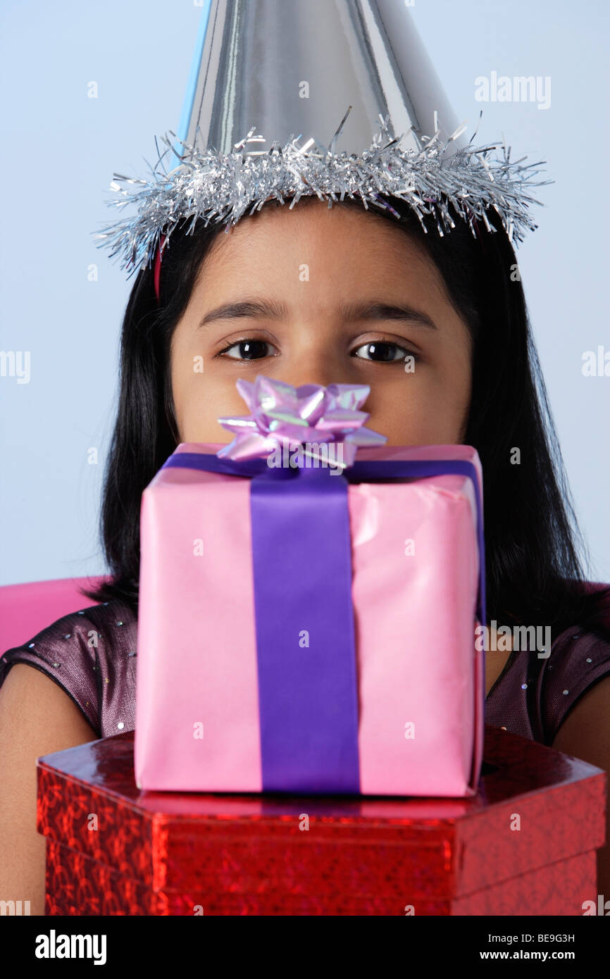 Little girl holding birthday presents Stock Photo - Alamy